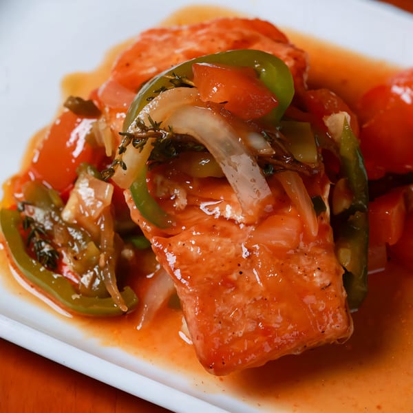Caribbean-style fish with bell peppers, onions, tomatoes, and herbs in a rich red sauce.